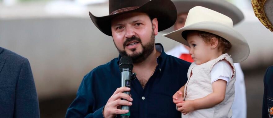Hombre con sombrero y su niña en brazos